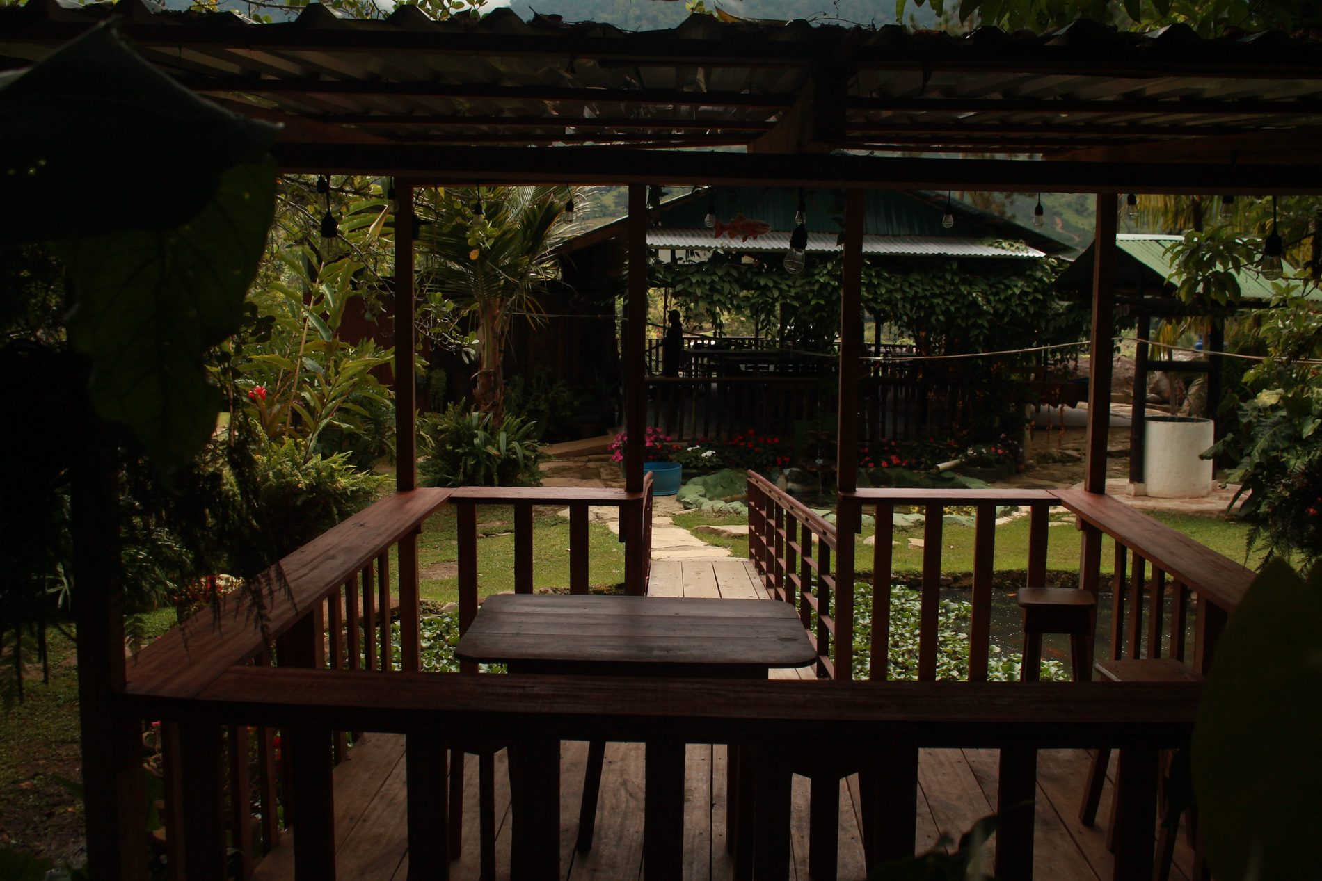 Quiosco de madera con mesa mirando al jardín